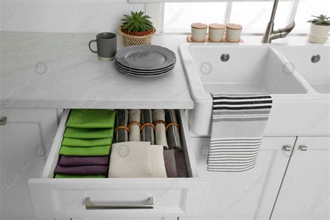 Open drawer with different folded towels and napkins in kitchen: Stock ...