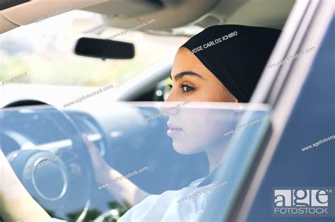 Woman looking through window while driving car, Stock Photo, Picture ...