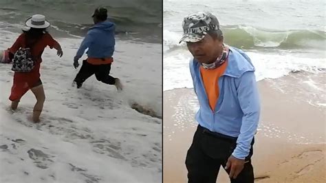 惊险！海南一女游客为捡拖鞋险被卷入大海男子冲进浪中及时救起_腾讯视频
