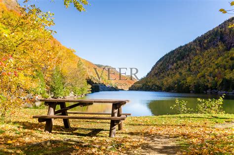 一个晴朗的秋日，山湖上的空野餐桌照片摄影图片_ID:133837564-Veer图库