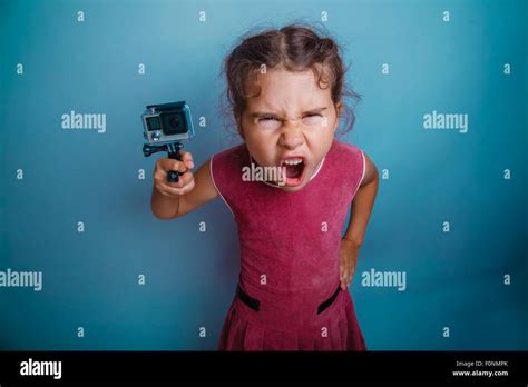 teen girl holding a camera action screams mouth opened photo stu Stock ...