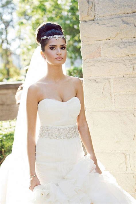 beautiful bride in ivory a-line style gown with feather hair piece ...