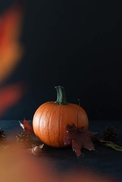 Premium Photo | Pumpkin and autumn maple leaves over black background ...
