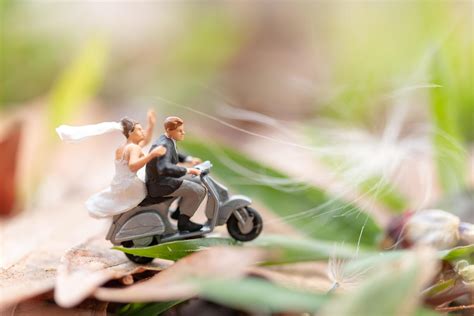 Miniature couple riding a motorcycle in a garden 2150435 Stock Photo at ...