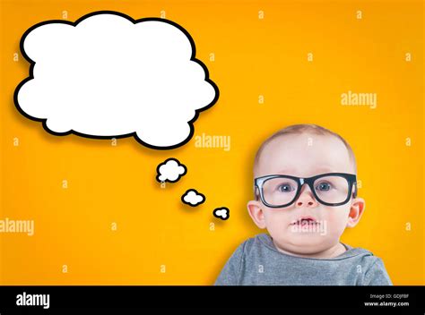 Thinking baby with glasses on an orange background Stock Photo - Alamy