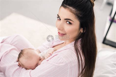 年轻母亲在家中哺乳的小婴高清图片下载-正版图片502761292-摄图网